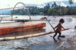 Child pulling in a boat on the East Coast